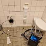 Professional pipe cleaning service using high-pressure water jetting to remove blockages and debris from residential drain pi