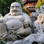 Handcrafted antiker Buddha statue representing centuries-old Asian spiritual traditions and meditation practices
